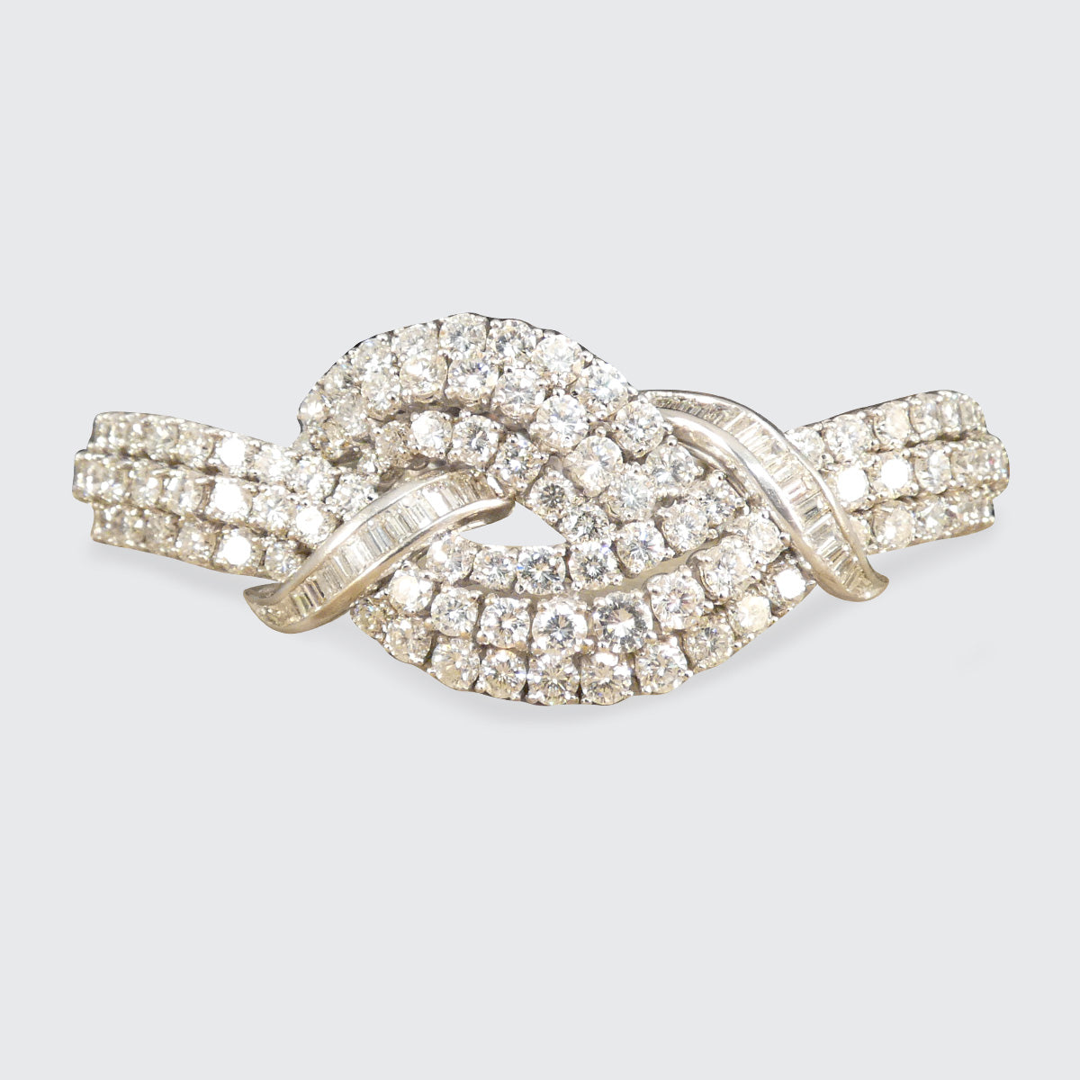 Vintage 1960s diamond bracelet featuring over 20ct of dazzling diamonds, intricately set in a knot design with exceptional craftsmanship in 18ct white gold.