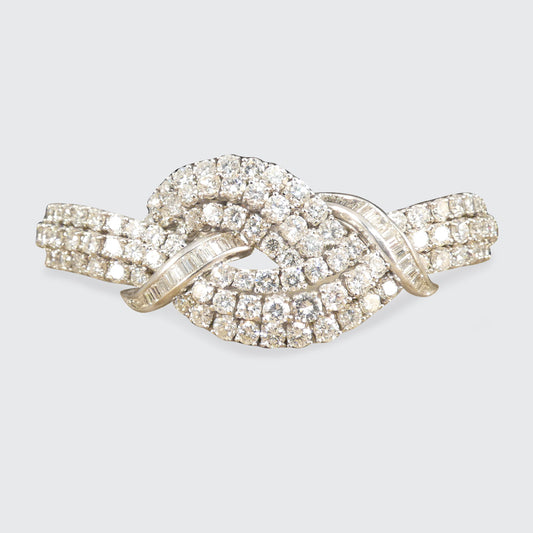 Vintage 1960s diamond bracelet featuring over 20ct of dazzling diamonds, intricately set in a knot design with exceptional craftsmanship in 18ct white gold.