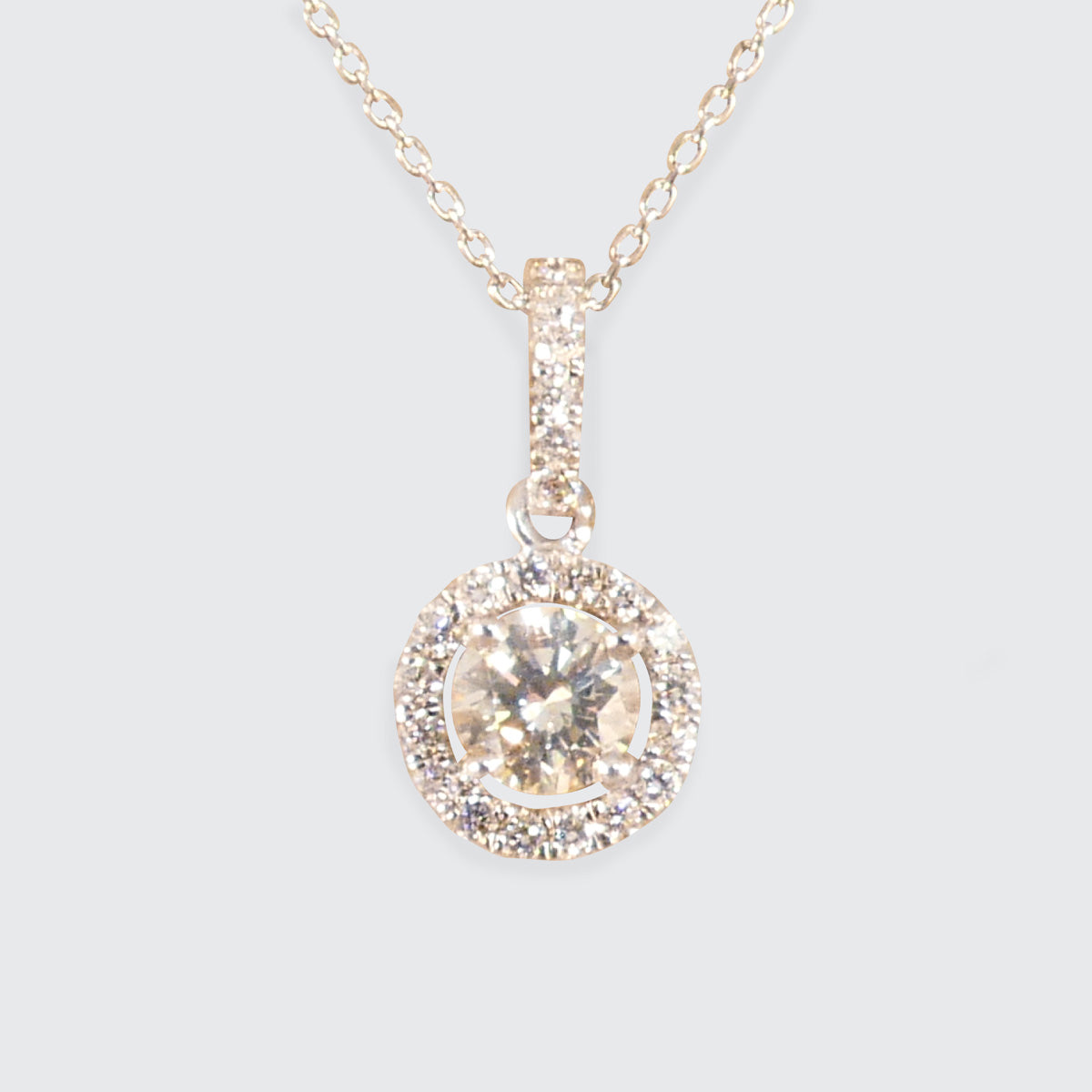 Elegant diamond halo cluster necklace in platinum, featuring a dazzling central diamond surrounded by a halo of sparkling stones, suspended from a delicate chain—an ideal gift for any special occasion.