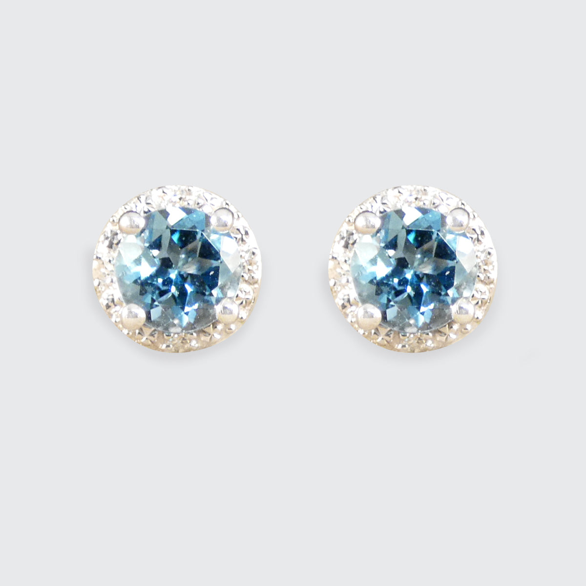 Contemporary Blue Topaz and Diamond Illusion cluster earrings in 9ct white Gold with sparkle and bright vibrant colour.