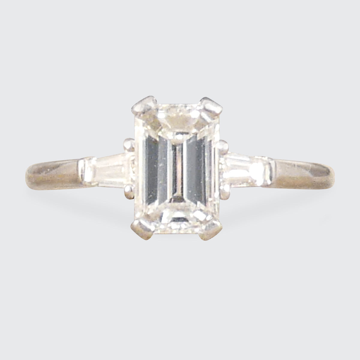 Emerald Cut Diamond Engagement Ring with Tapered Baguette Shoulders in Platinum. The perfect give and timeless ring.