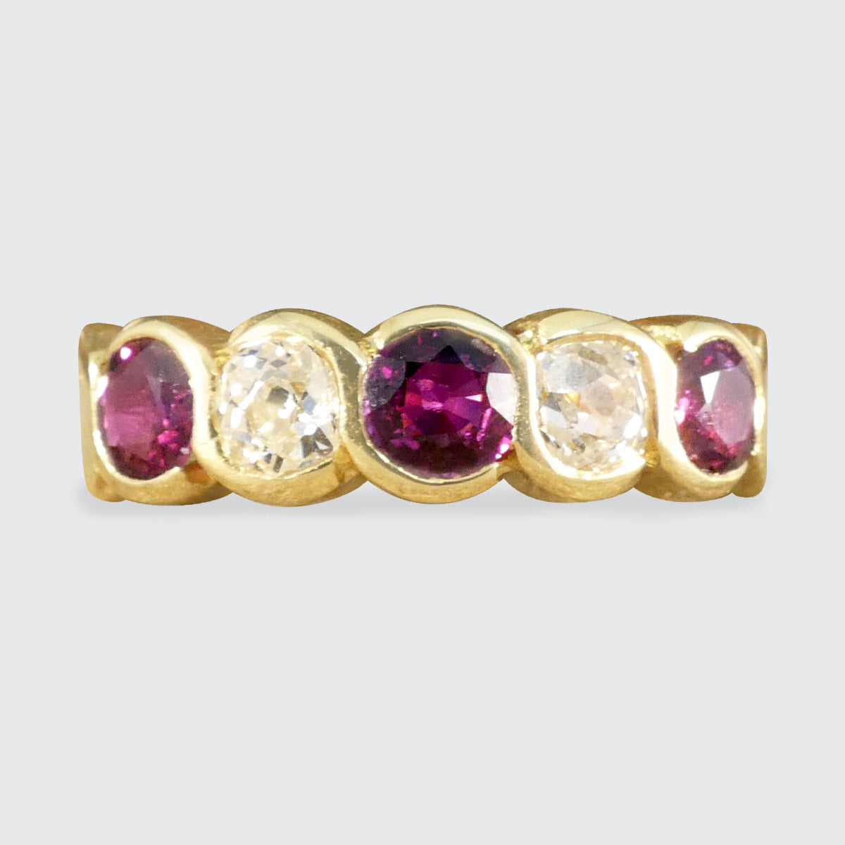 Vintage five-stone ring showcasing vibrant rubies and sparkling diamonds in a bold, chunky design, crafted in 18ct yellow gold.