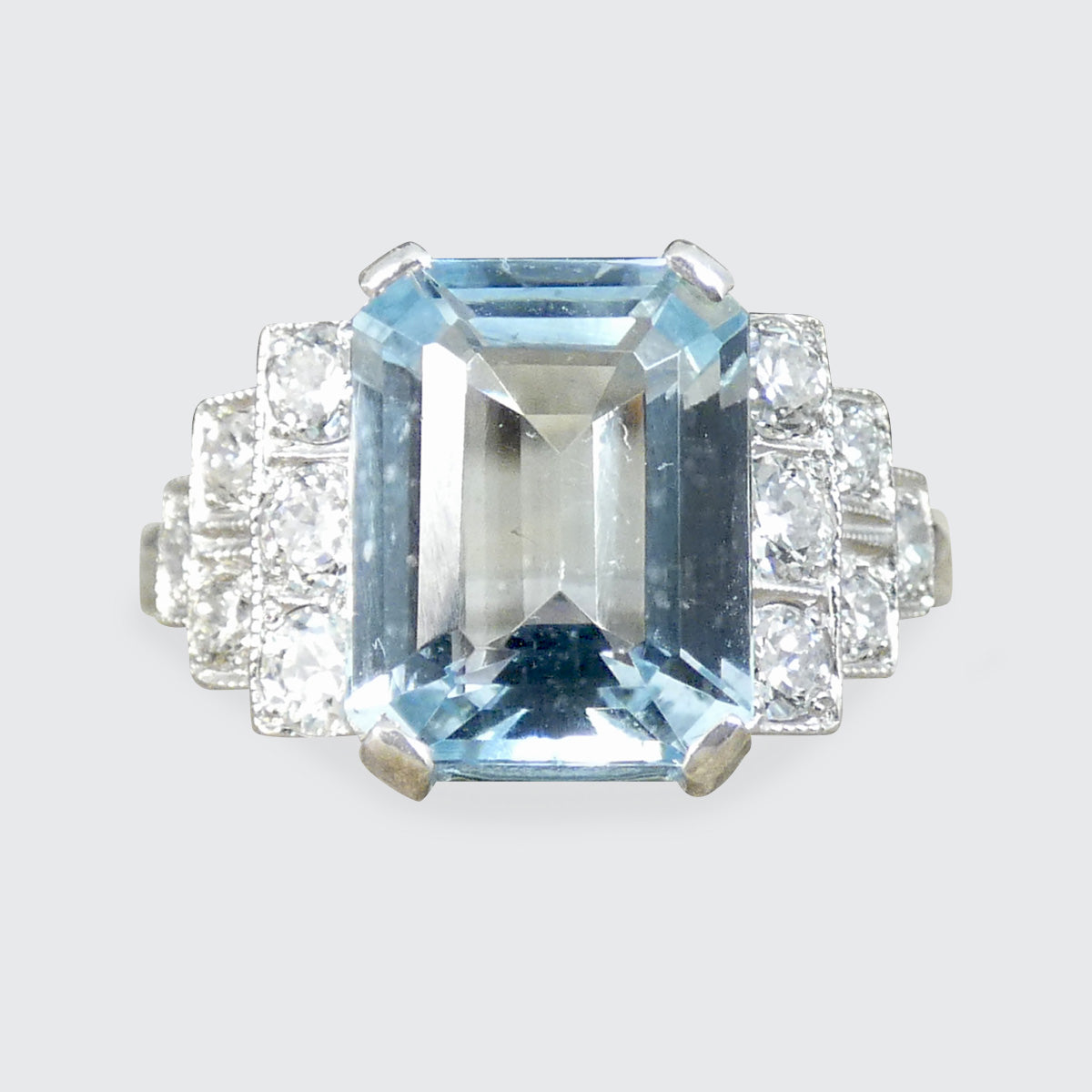 An Art Deco style ring that has been newly crafted with a 3.00ct light blue Aquamarine with graduated staged set Diamond shoulders in Platinum.