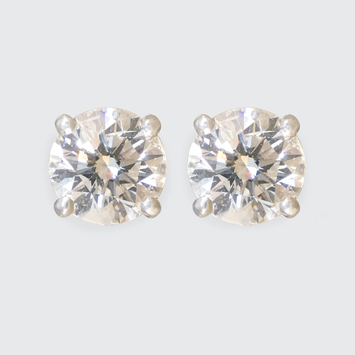 A pair of Diamond stud earrings in a classic four claw setting in Platinum.