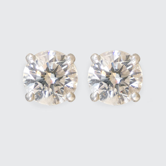 A pair of Diamond stud earrings in a classic four claw setting in Platinum.