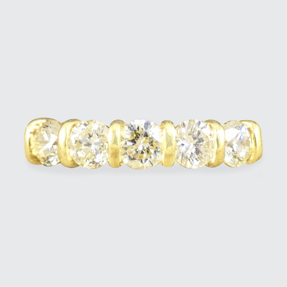 Warm and honey tinted five stone diamond ring with a bar setting in 18ct Yellow Gold.