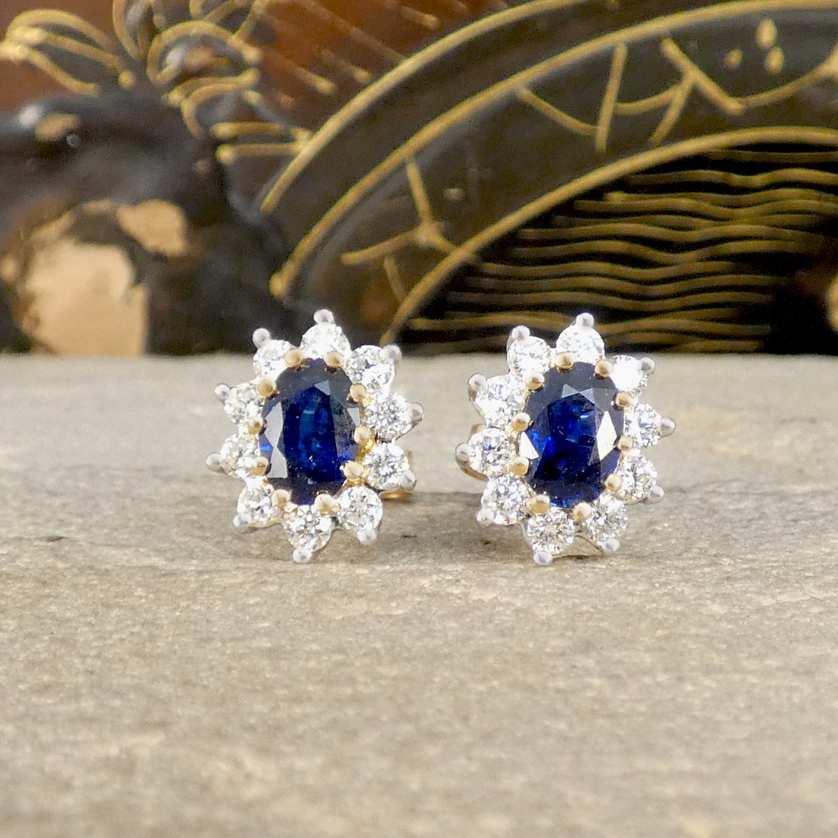 Classic Sapphire and Diamond cluster stud earrings in 18ct Yellow and White Gold. Showing a deep and mesmerising blue hue.