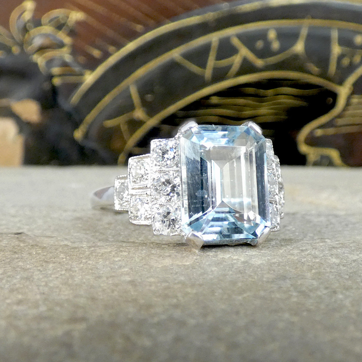 An Art Deco style ring that has been newly crafted with a 3.00ct light blue Aquamarine with graduated staged set Diamond shoulders in Platinum. Showing off the subtle hint of blue.