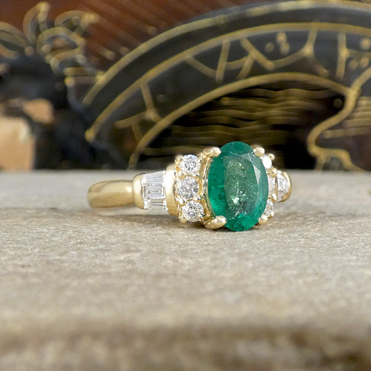 Side view of Emerald ring in a four claw setting weighing 1.00ct with typical Emerald flaws throughout and a lovely forest green colour.