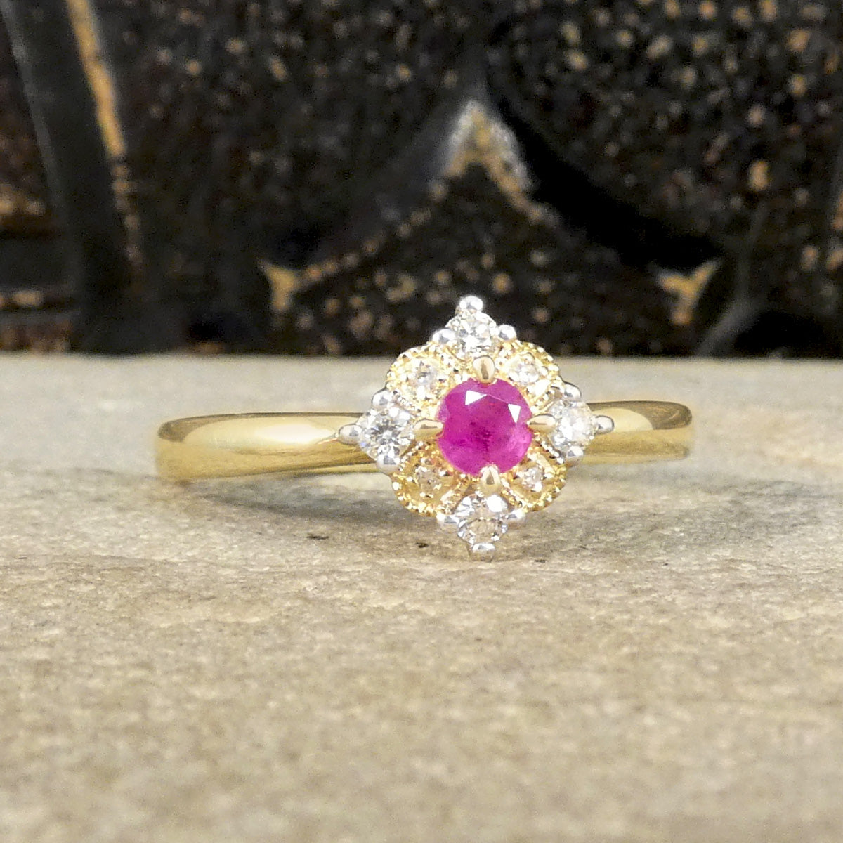 Ruby and Diamond Cross Section Illusion Set Ring in Yellow and White Gold showing a bright pink hue in the ruby and a gold cluster ring with a difference.