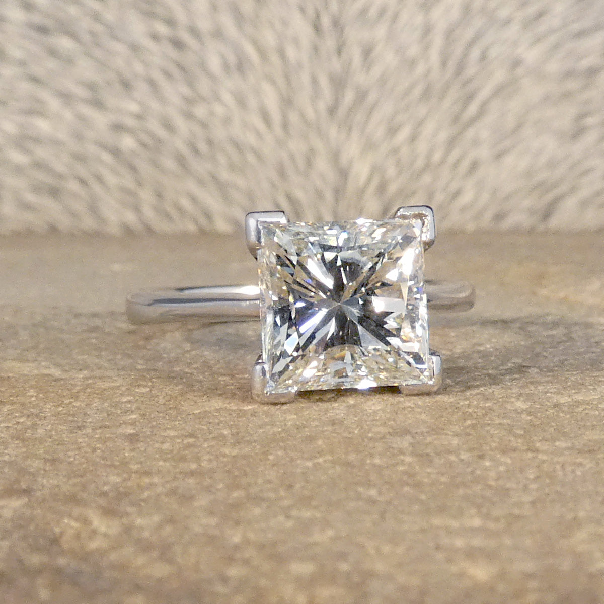 The perfect engagement ring in 18ct White Gold with a central 2.95ct Princess Cut Diamond in a four corner claw setting.