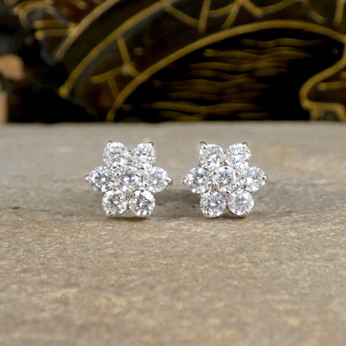 Close up of Daisy cluster earrings featuring 7 equal diamonds to create the cluster.