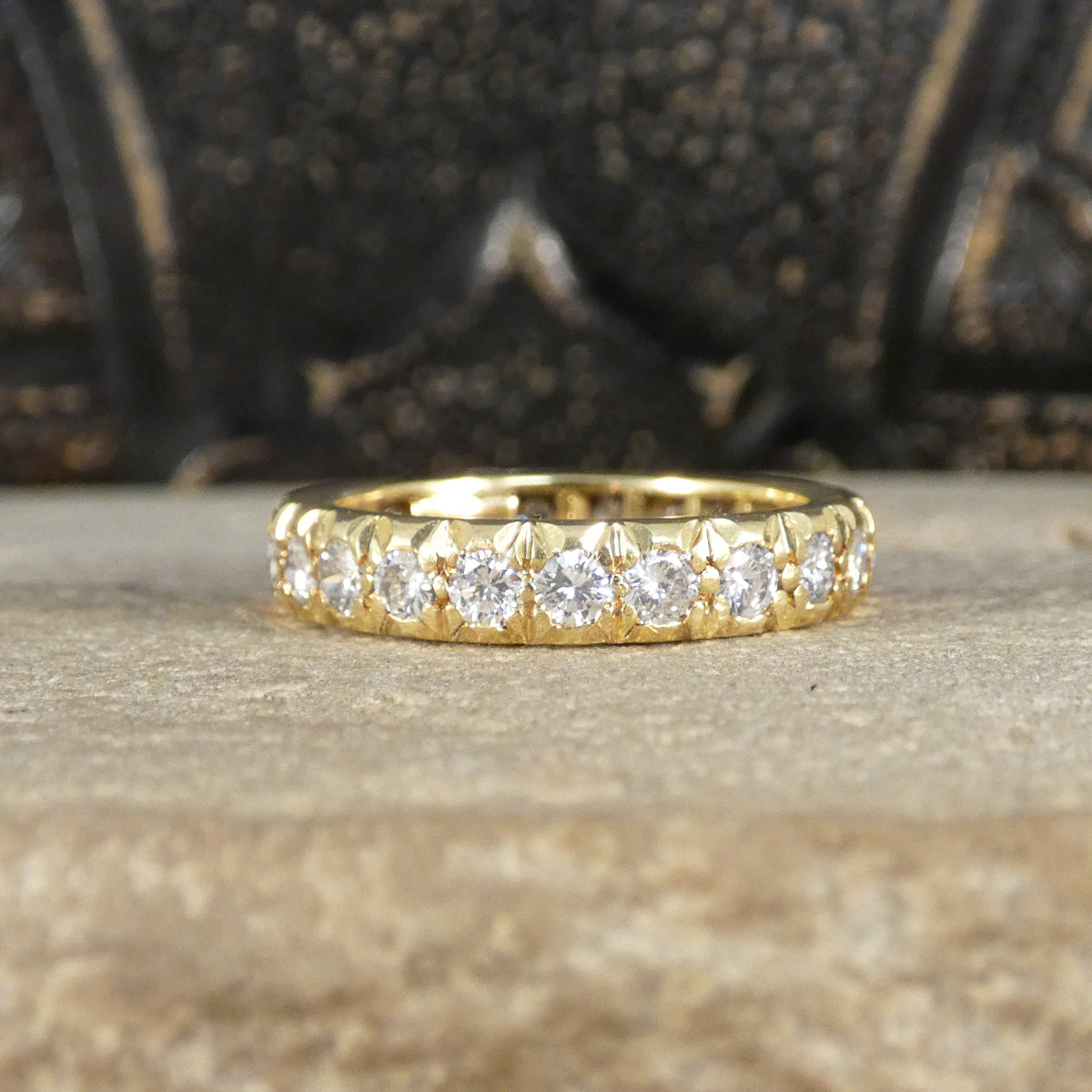 Full eternity band crafted in 18ct yellow gold, featuring bright and clear diamonds totalling 1.33ct set around the entire band with intricate detailing.