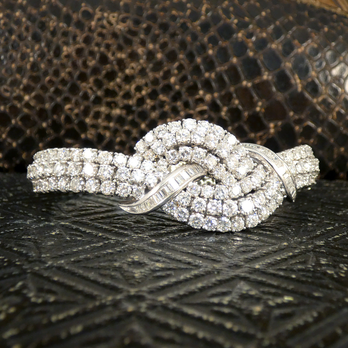 Vintage 1960s diamond bracelet featuring over 20ct of dazzling diamonds, intricately set in a knot design with exceptional craftsmanship in 18ct white gold.