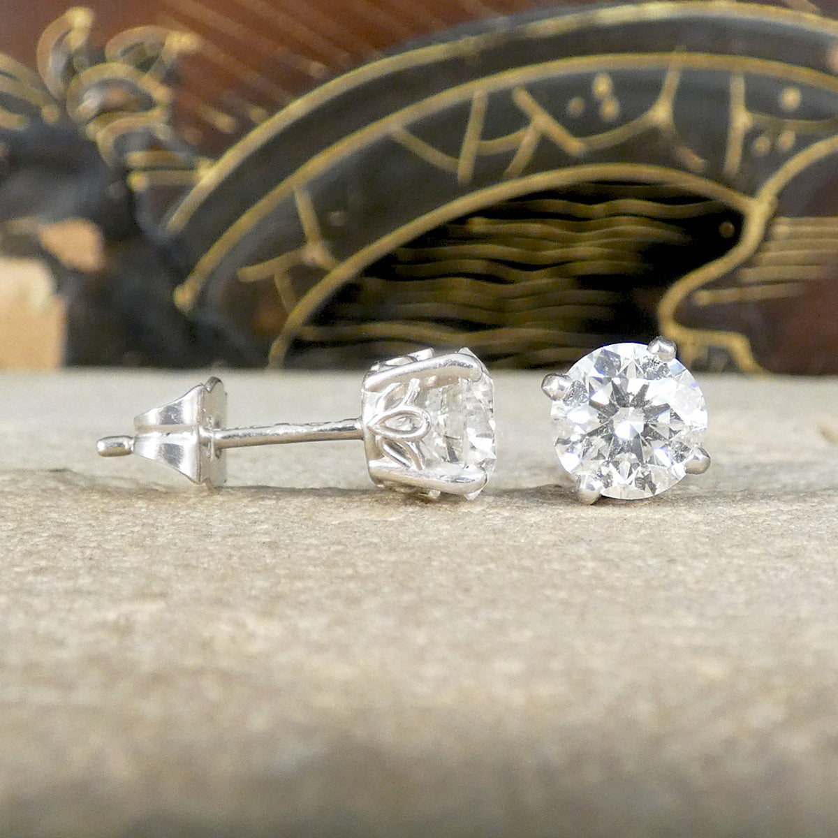 Two single Diamond studs, one from the side profile and the other front the front to show both.