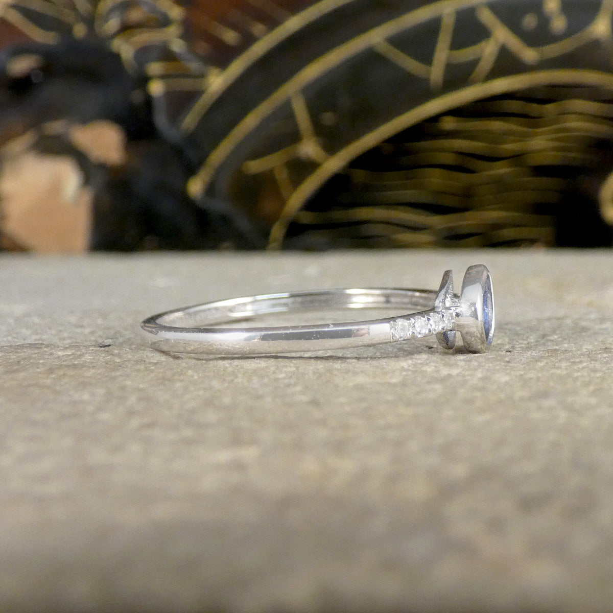 Side view of Sapphire and Diamond ring, showing how far the Diamonds are set on the shoulders leading to the plain polished band.