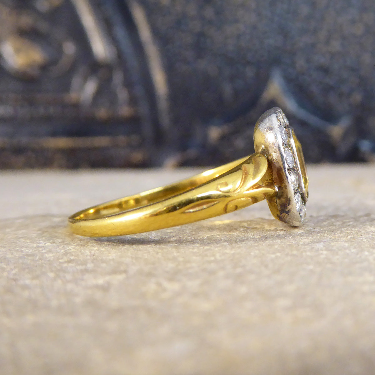 Side of Georgian style cluster ring showing the band tapering to the back showing the idea of age. Showcasing the setting and how it has metal and colour change from White to Yellow on the back.