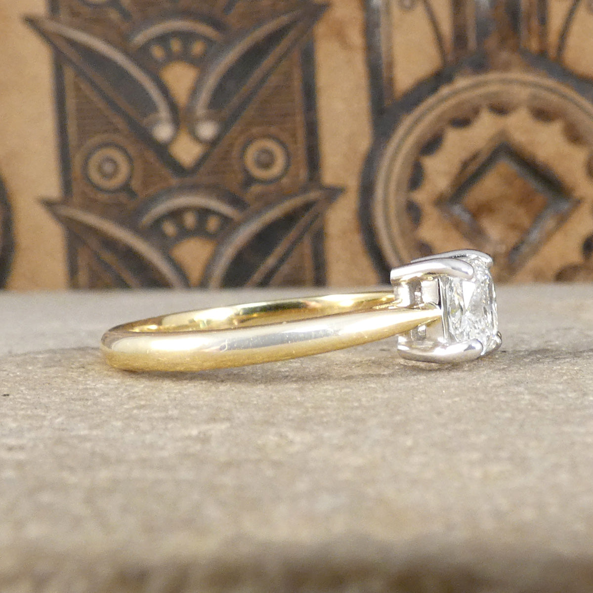 Side profile of toi et moi ring showing box settings and tapered shoulder iin 18ct yellow gold.