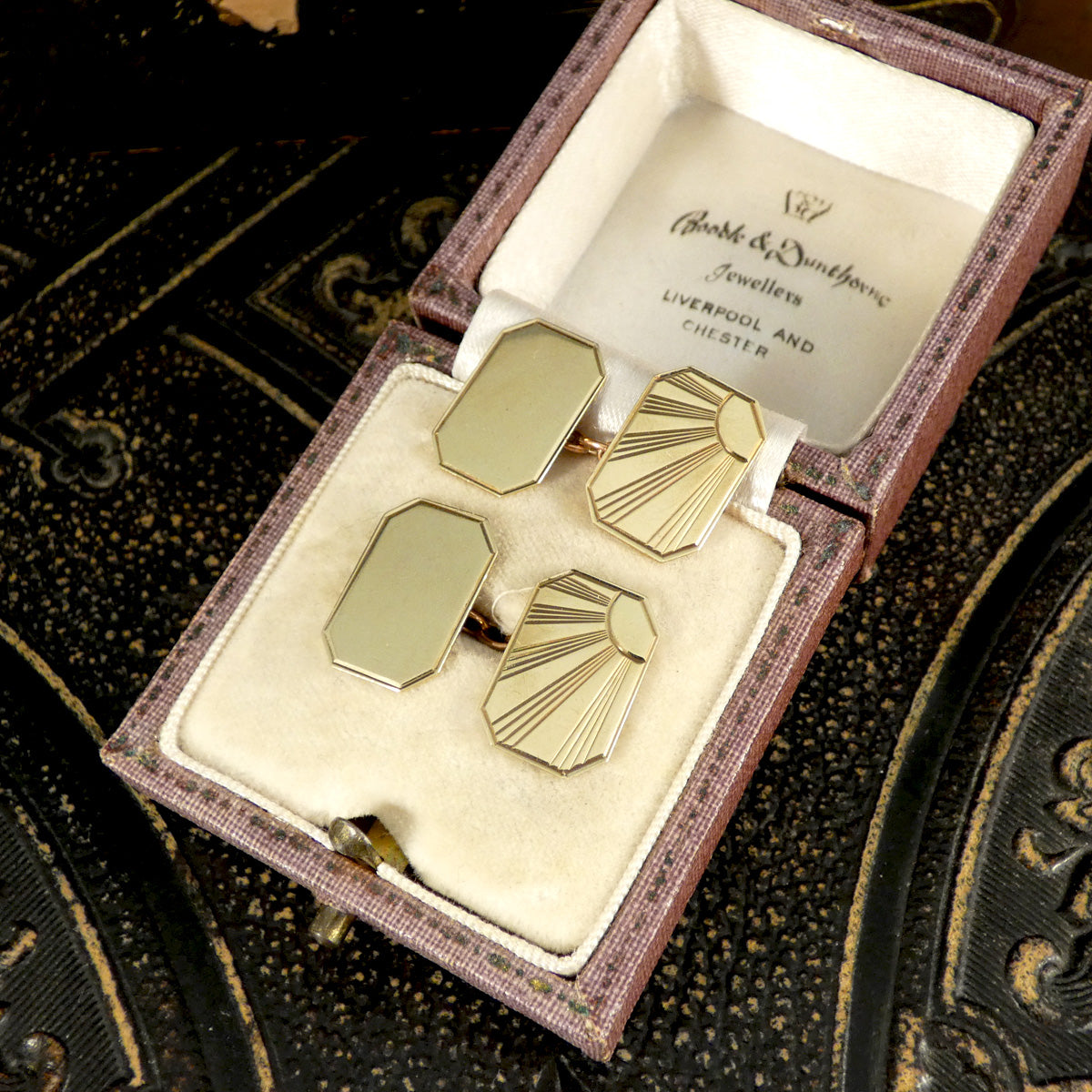 Elegant vintage cufflinks presented in their original jeweller's box, showcasing a timeless Art Deco sunburst design. The polished gold-tone finish and versatile style make these a perfect gift or addition to any formal collection.