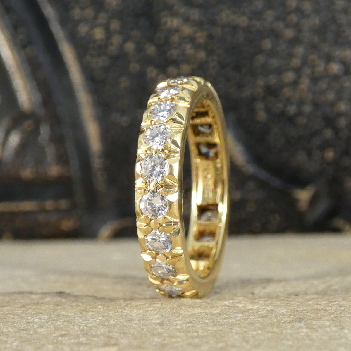 Full eternity band crafted in 18ct yellow gold, featuring bright and clear diamonds totalling 1.33ct set around the entire band with intricate detailing.