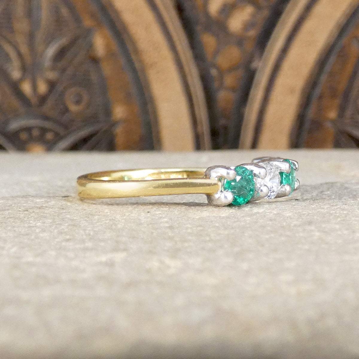 Side profile of Emerald and Diamonds five stone ring set in 18ct White Gold with an 18ct Yellow Gold band.