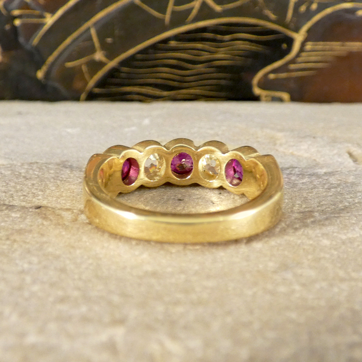 Back view of Vintage five-stone ring showcasing vibrant rubies and sparkling diamonds in a bold, chunky design, crafted in 18ct yellow gold with a waved bezel setting.