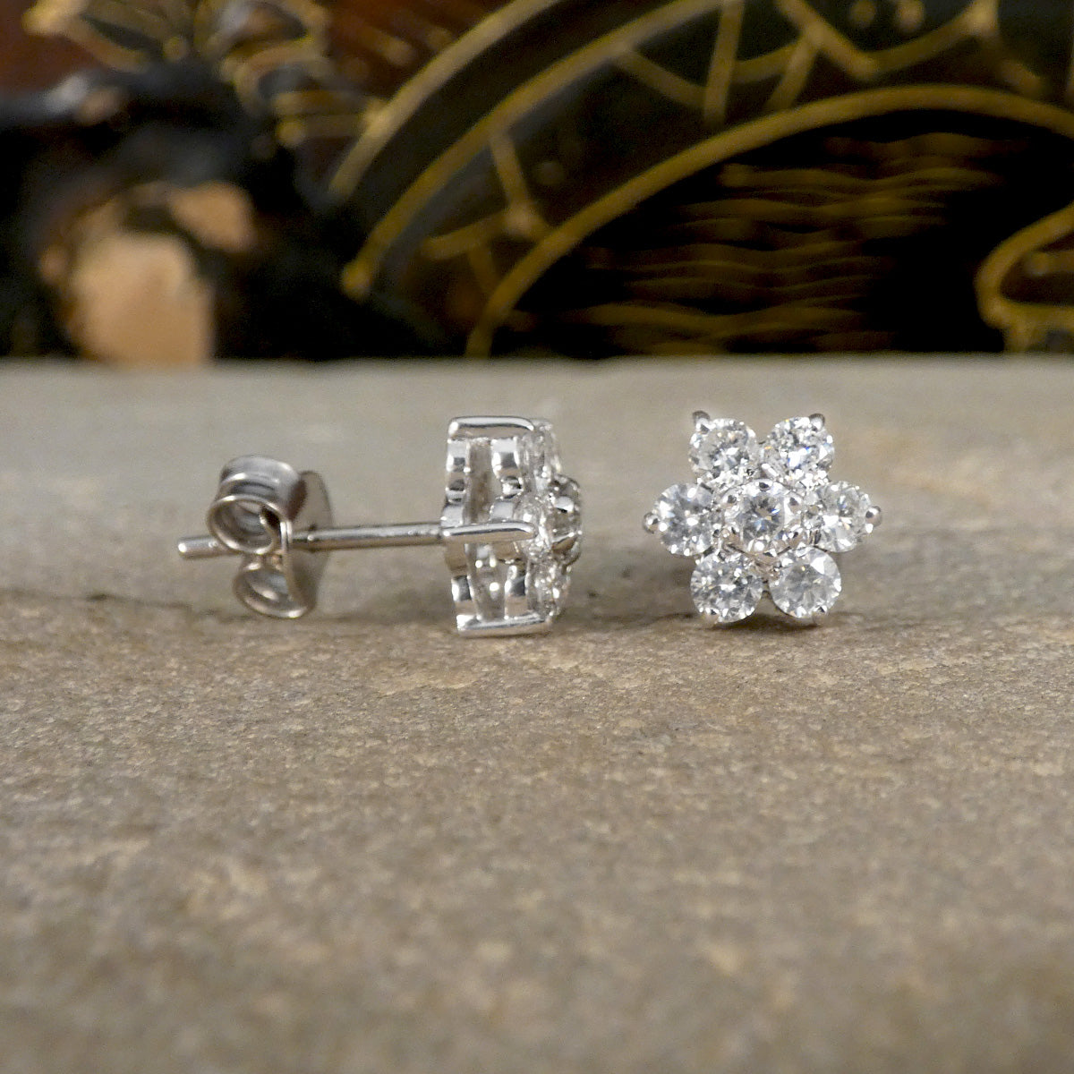 Front and side view of Daisy cluster stud earrings to see the open setting, allowing light to pass through diamonds creating sparkle.