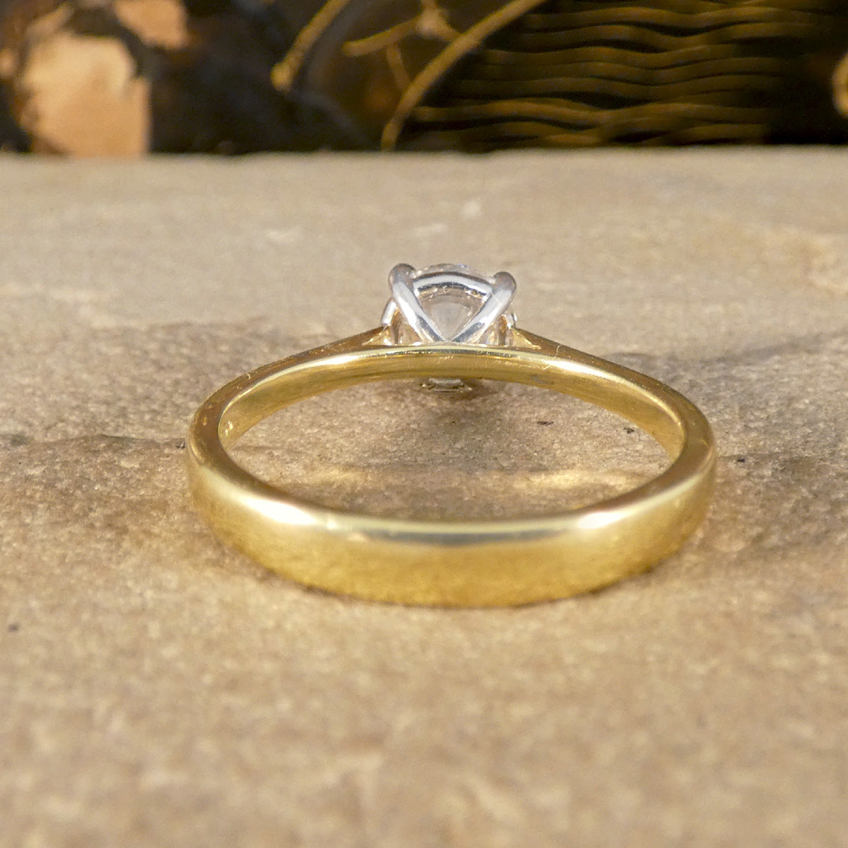 The back of a Diamond solitaire engagement ring demonstrating how open the setting is from the back allowing light to pass through the stone allowing more sparkle.