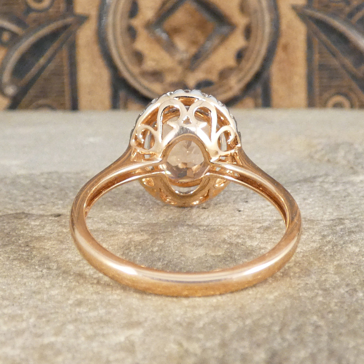 Back view of Morganite and Diamond cluster ring with a detailed basket setting in a warm Rose Gold and substantial band.