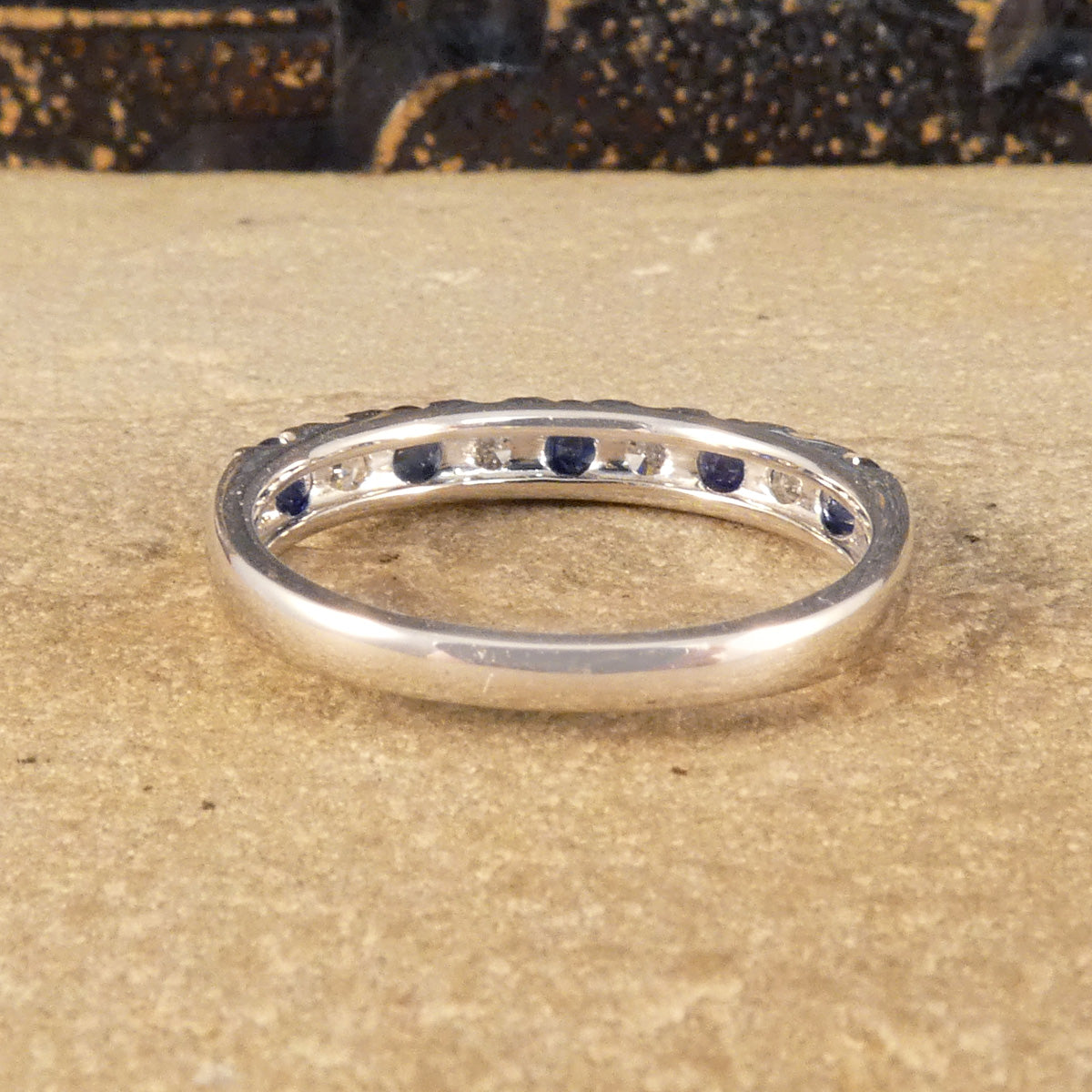 Back view of Alternating blue Sapphire and Diamond half eternity ring in white gold to complement the stones.