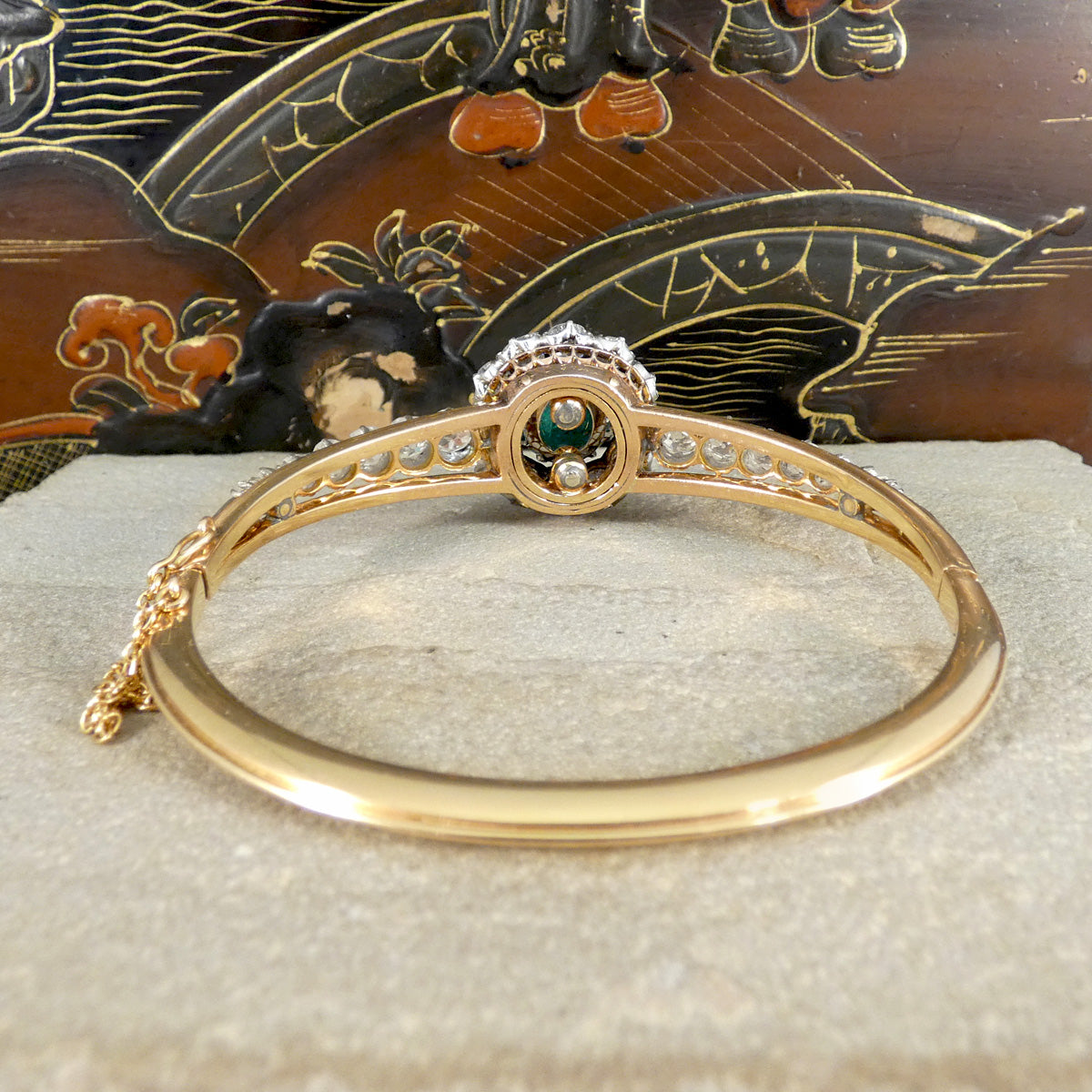 Rear view of the late Victorian cabochon emerald and diamond bangle, showcasing the intricate craftsmanship with detailed openwork, secure settings, and high-quality gold finishing.