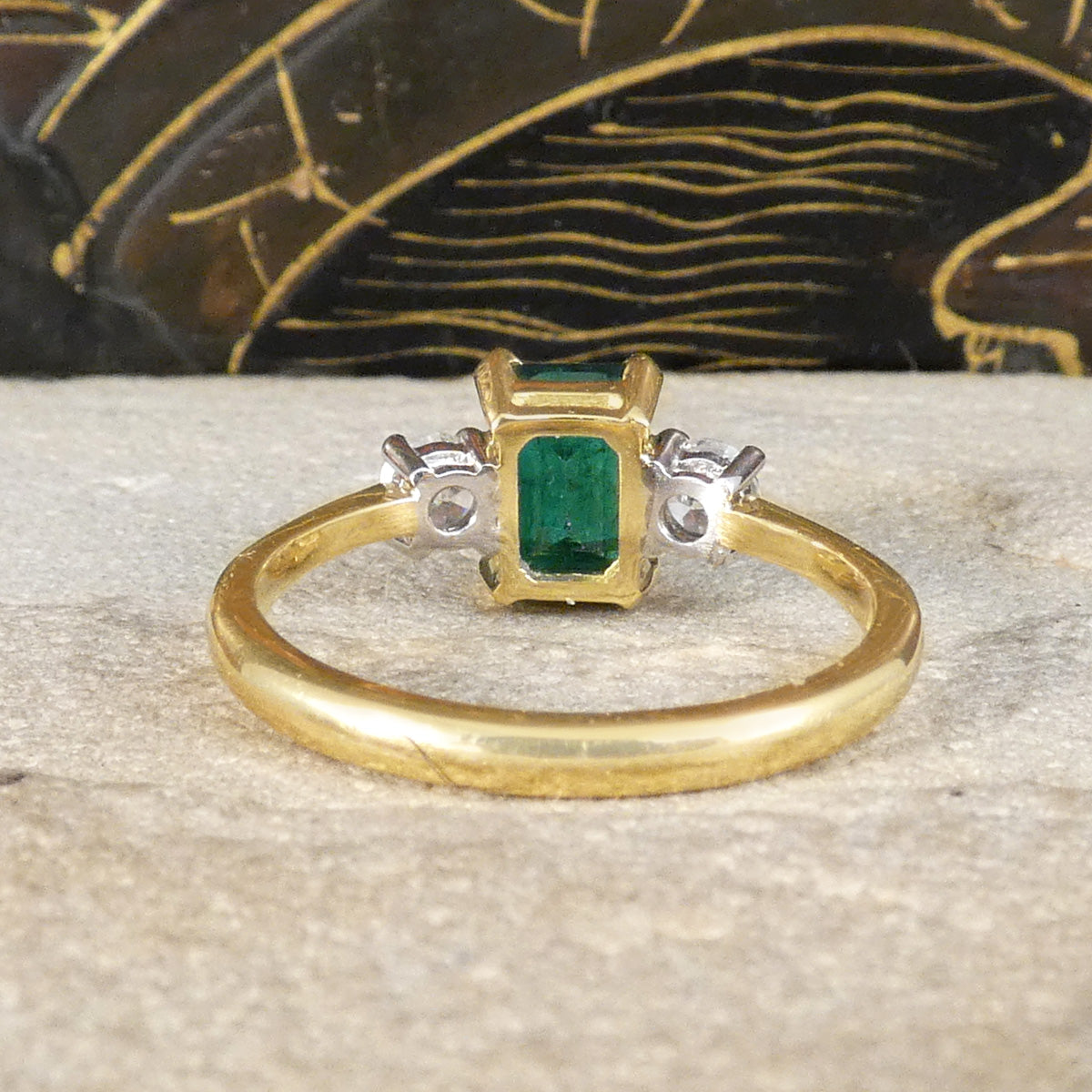 Back view of Edwardian style classic Emerald Cut Emerald and Old Cut Diamond three stone ring in 18ct Yellow and White Gold. Showing open setting, allowing light to pass through feely.