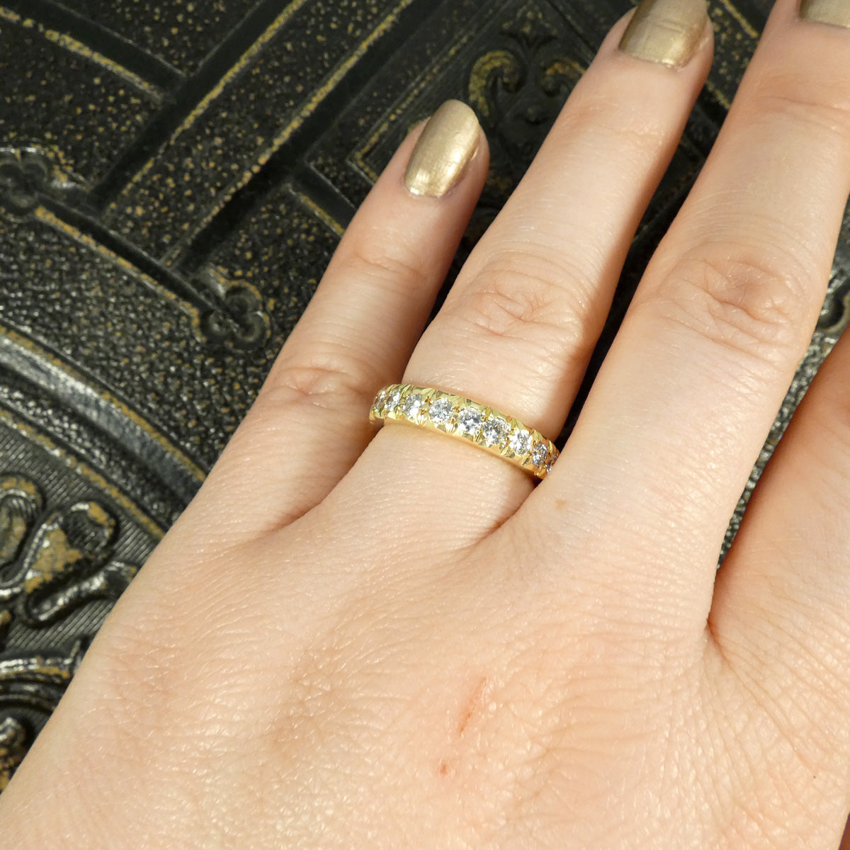 Full eternity band crafted in 18ct yellow gold, featuring bright and clear diamonds totalling 1.33ct set around the entire band with intricate detailing. Modelled on finger to show sparkle and ring for size.