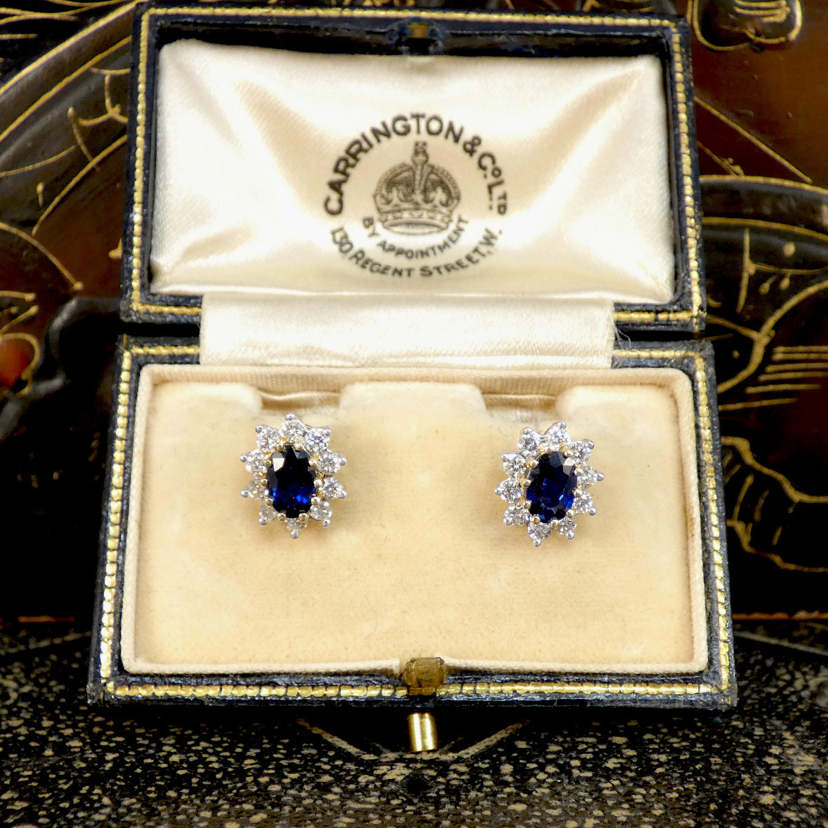 Classic Sapphire and Diamond cluster stud earrings in 18ct Yellow and White Gold. Showing a deep and mesmerising blue hue. Displayed in vintage box making the perfect gift.