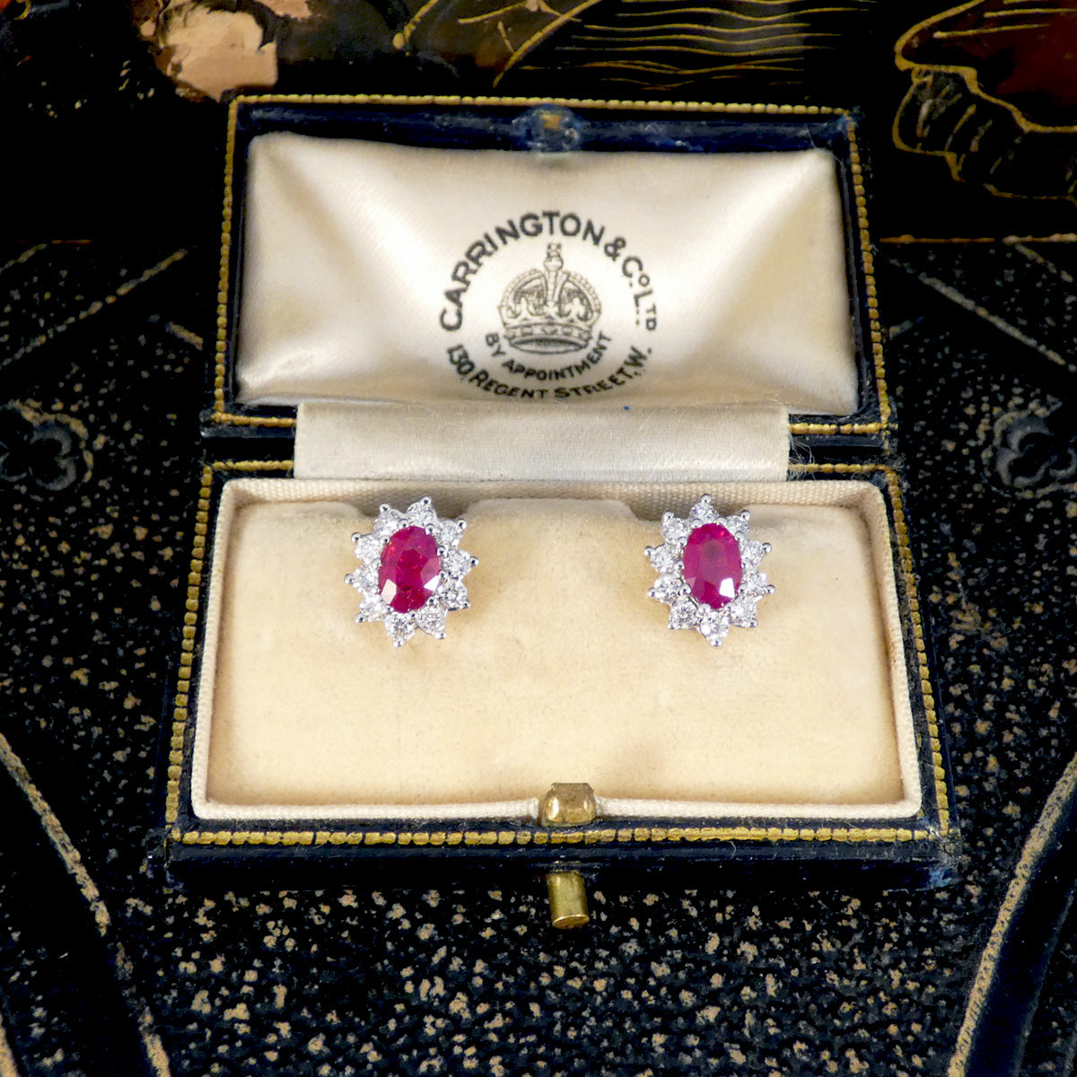 Ruby and Diamond Cluster Stud Earrings in 18ct White Gold, in a classic setting that will stand the test of time. Featuring a bright and pinkish oval cut Ruby in each stud with a cluster of Diamonds in 18ct White Gold. Perfect gift idea. 40th anniversary present.