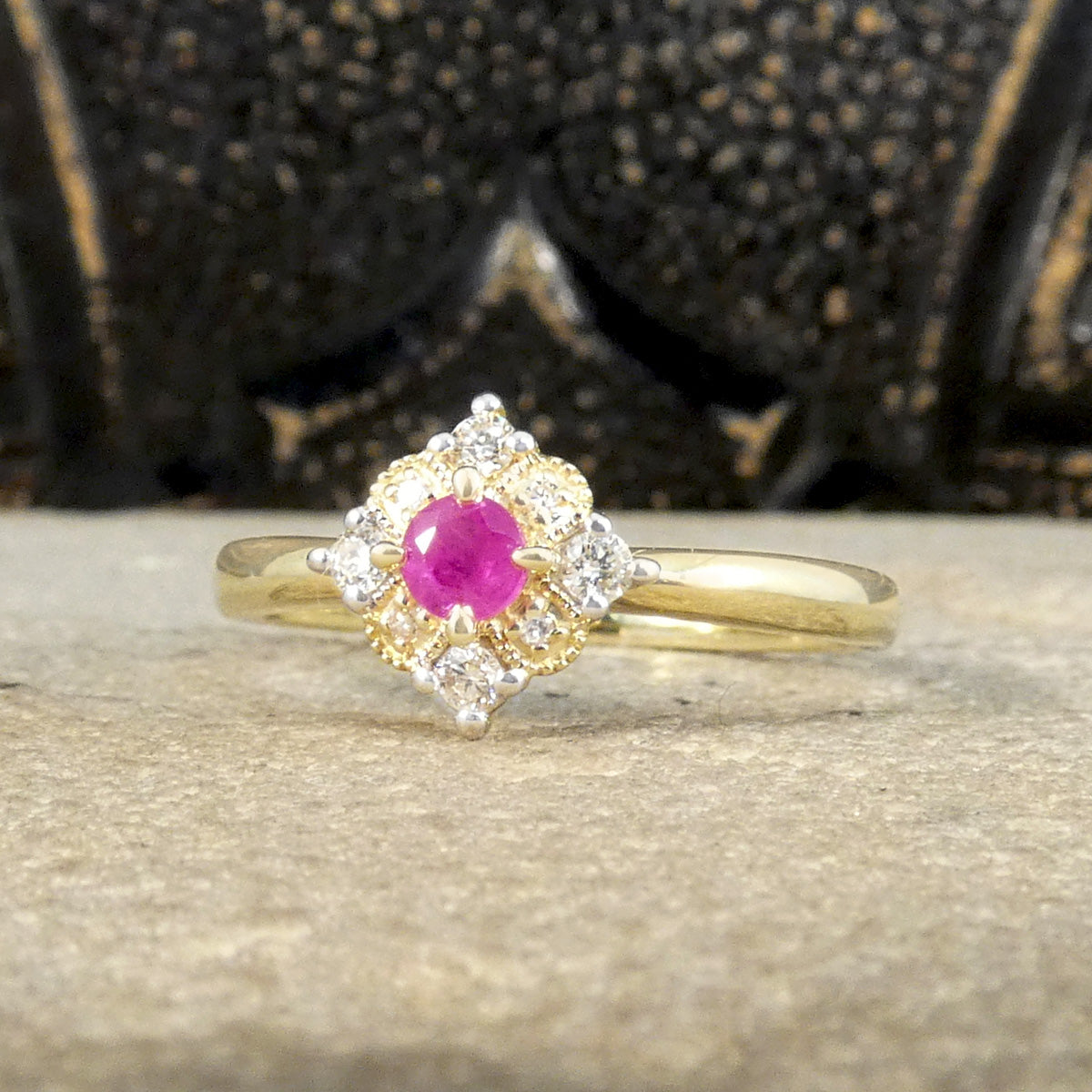 Ruby and Diamond Cross Section Illusion Set Ring in Yellow and White Gold showing a bright pink hue in the ruby and a gold cluster ring with a difference.