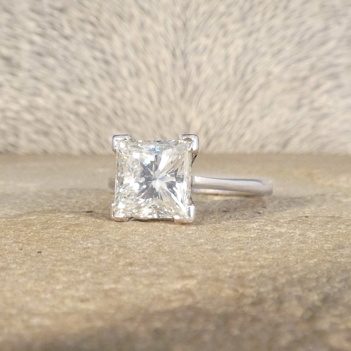 Solitaire Princess cut with an excellent cut and maximising sparkle throughout.