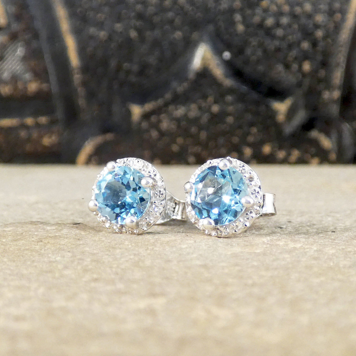 Round cut blue topaz and diamond cluster stud earrings, the perfect gift in white gold.