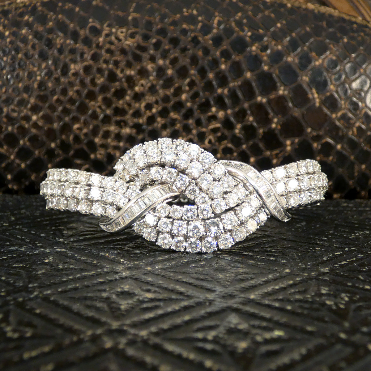 Vintage 1960s diamond bracelet featuring over 20ct of dazzling diamonds, intricately set in a knot design with exceptional craftsmanship in 18ct white gold.