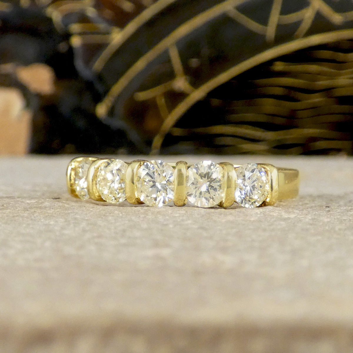 Showcasing five brilliant cut diamonds in a half eternity ring, oozing a warm yellow colour giving this five stone ring a difference.