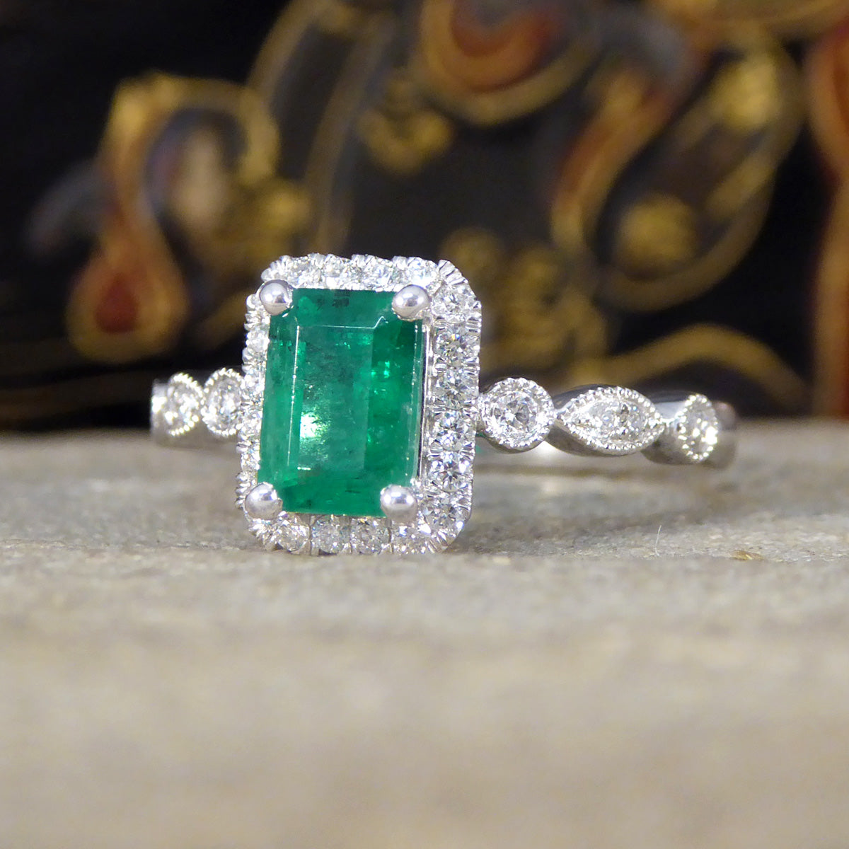 1.05ct Emerald and Diamond Cluster Ring with Diamond Adorned Shoulders in Platinum