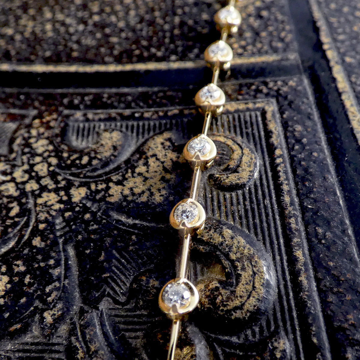 Close-up of the 18ct yellow gold diamond bracelet showcasing the brilliant-cut diamonds in rose basket bezel settings, emphasising the craftsmanship and elegance.