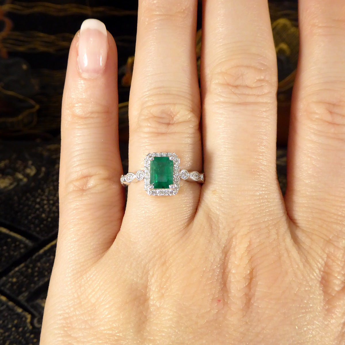 1.05ct Emerald and Diamond Cluster Ring with Diamond Adorned Shoulders in Platinum