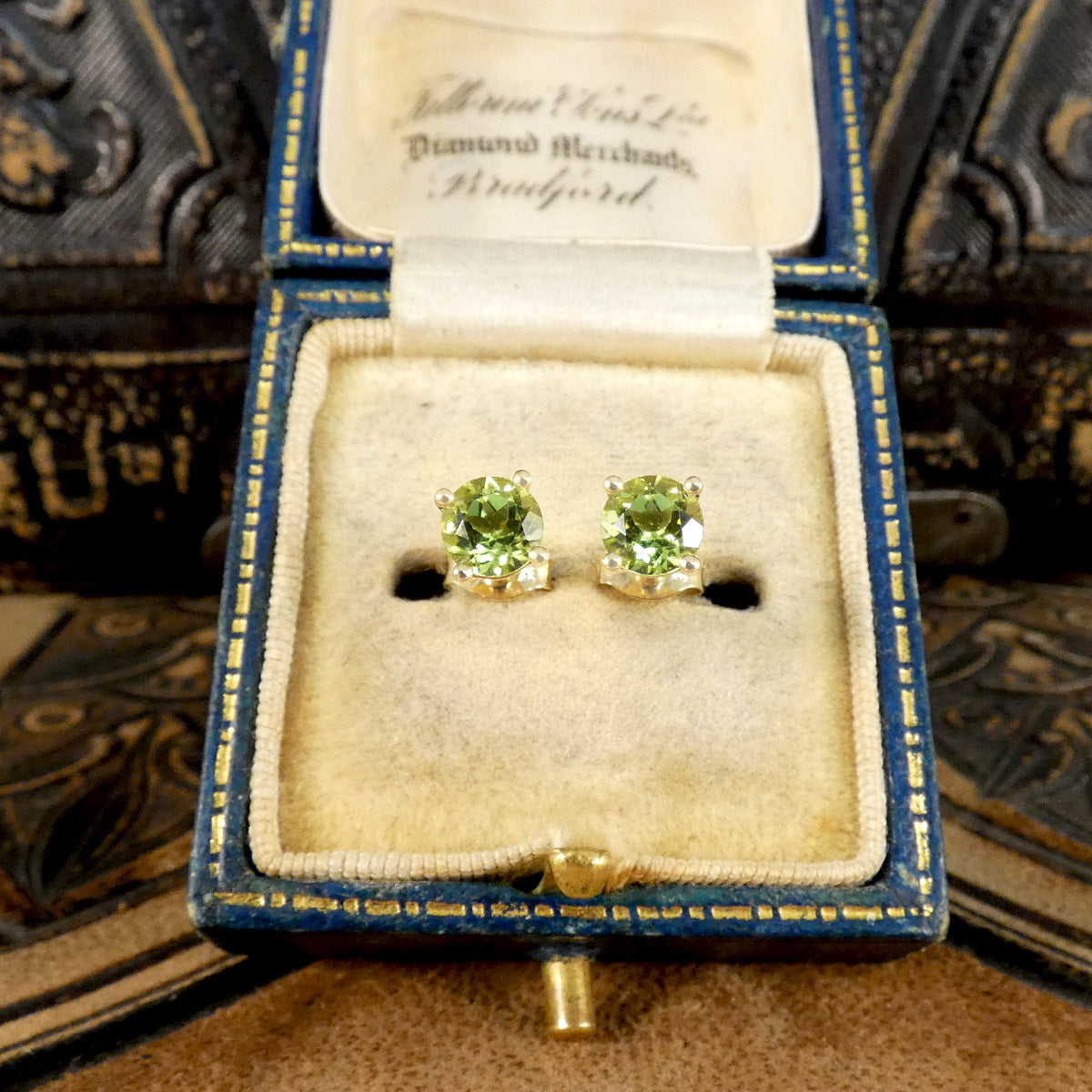 Four-claw peridot stud earrings crafted in 9ct yellow gold, featuring vibrant round-cut green gemstones with a classic and elegant design, in antique box, the perfect gift.