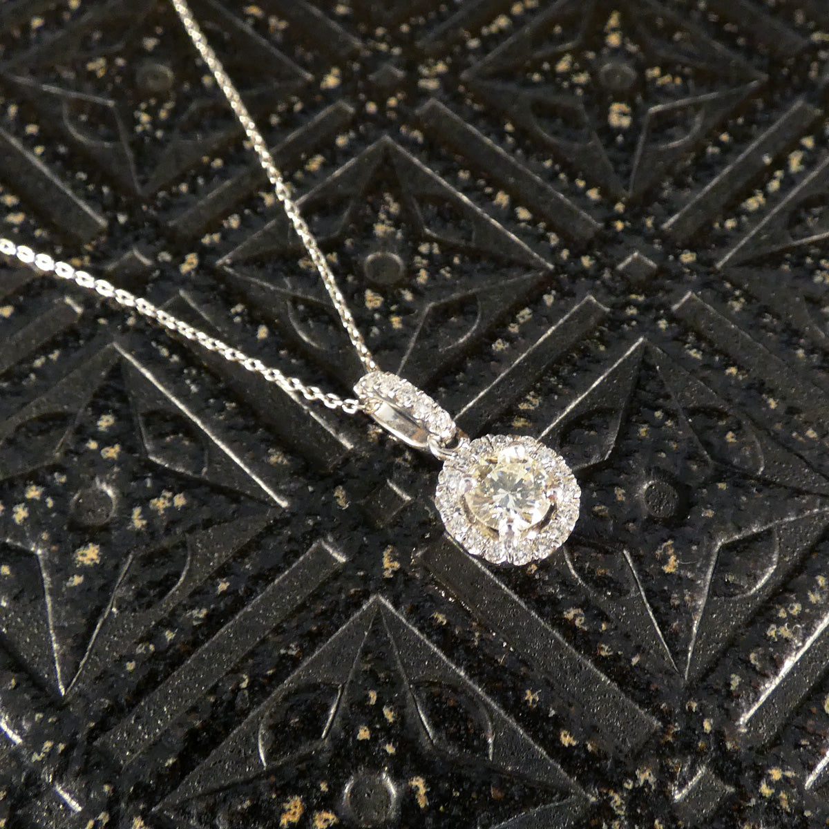 Elegant diamond halo cluster necklace in platinum, featuring a dazzling central diamond surrounded by a halo of sparkling stones, suspended from a delicate chain—an ideal gift for any special occasion.