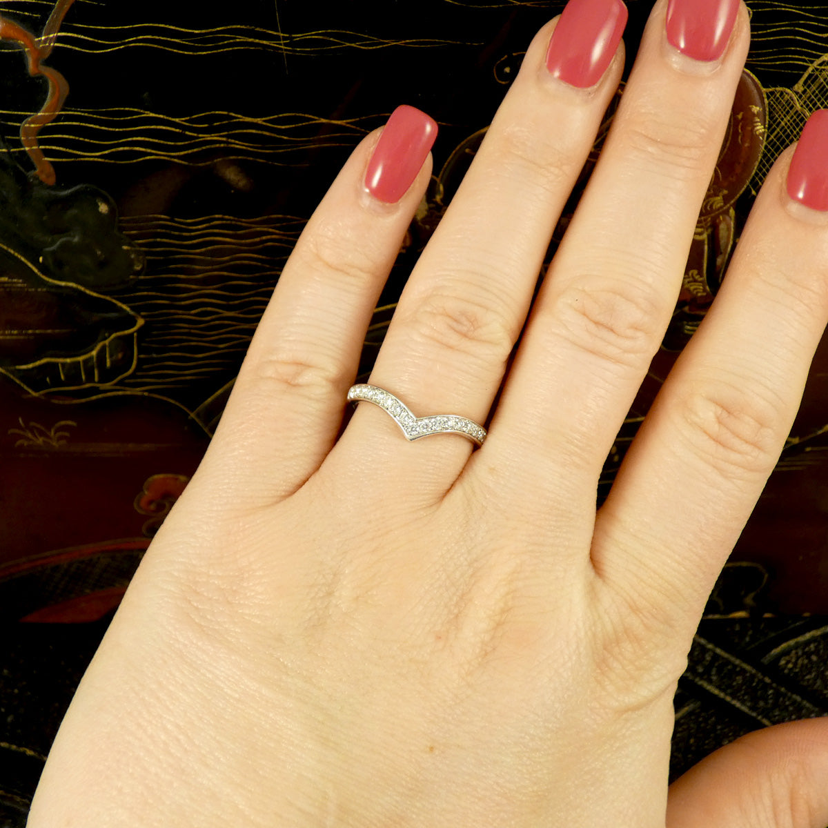 Diamond set wishbone ring in White Gold on the finger to show sizing in context.