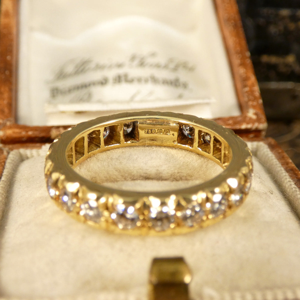 Full hallmarks for 18ct yellow gold in full eternity diamond set ring.