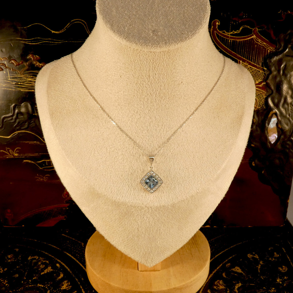 Strong blue Aquamarine and Diamond Cluster Pendant Necklace in Platinum with a solid platinum bail on a trace chain. Displayed on bust o see size ratio.