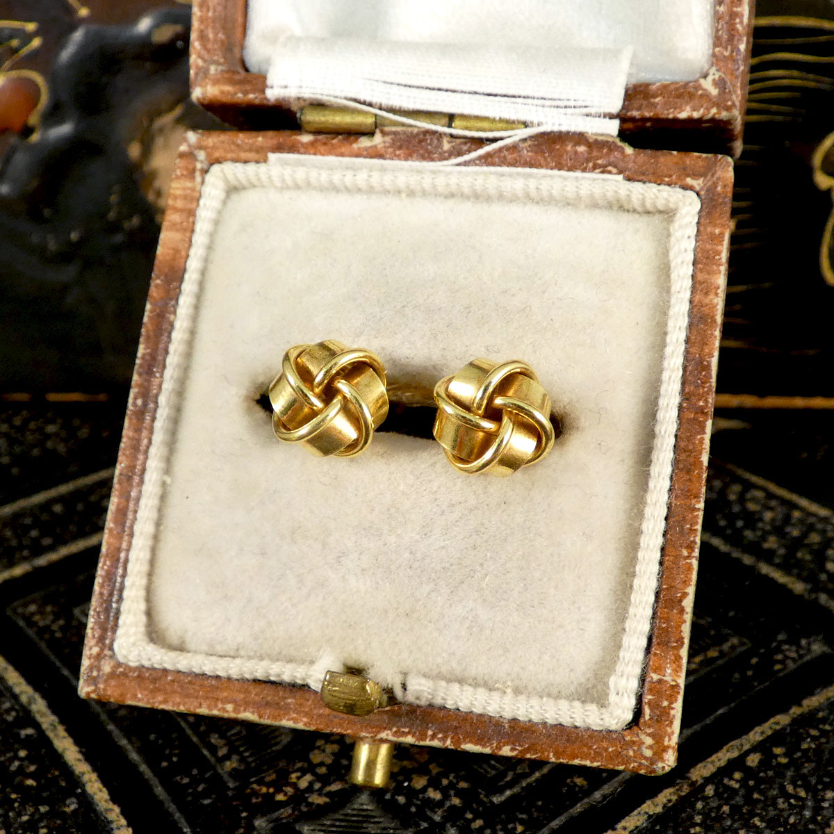 Vintage knot earrings in 9ct yellow gold elegantly presented in a vintage jewellery box, highlighting their sophisticated design and timeless appeal.