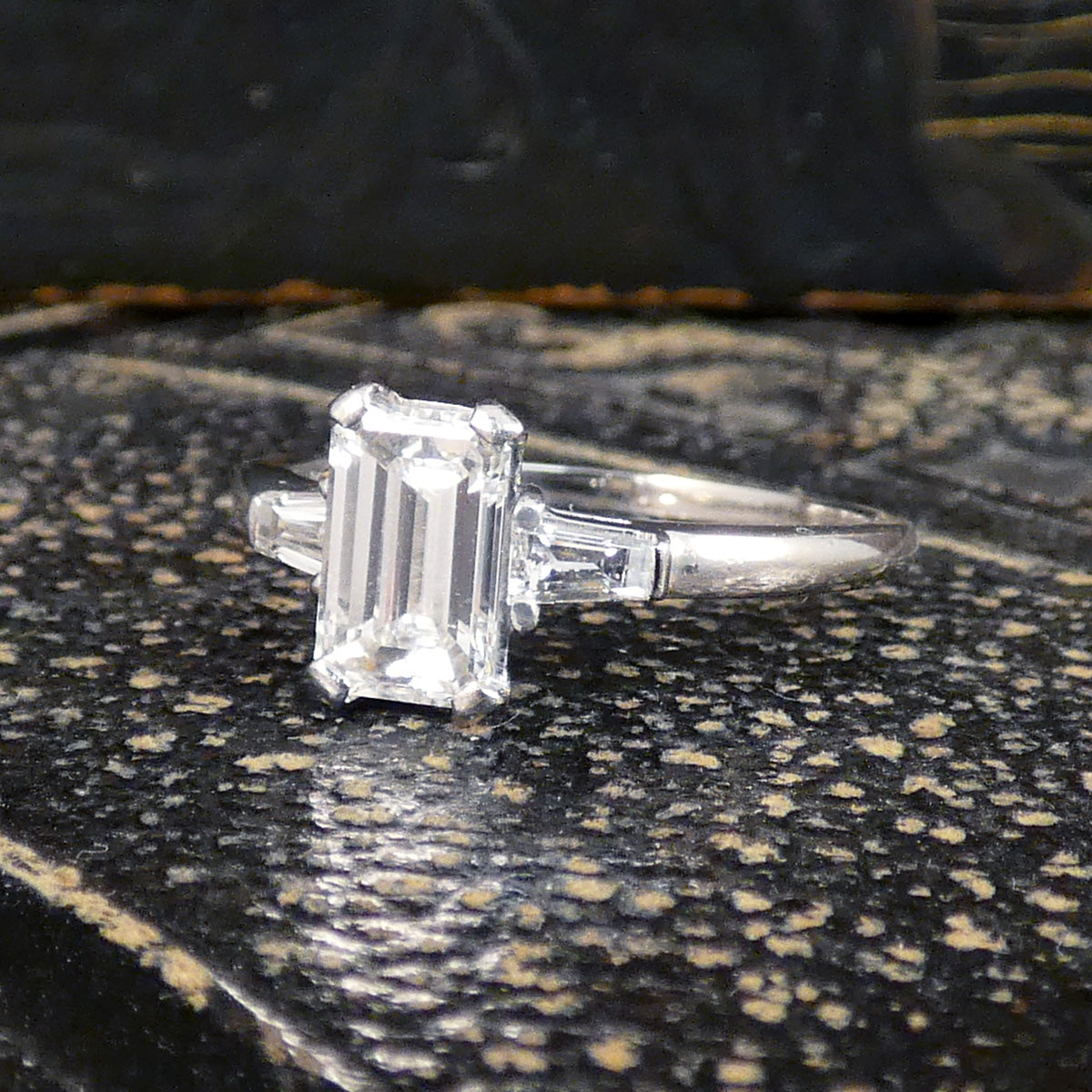 Emerald Cut Diamond Engagement Ring with Tapered Baguette Shoulders in Platinum. The perfect give and timeless ring.